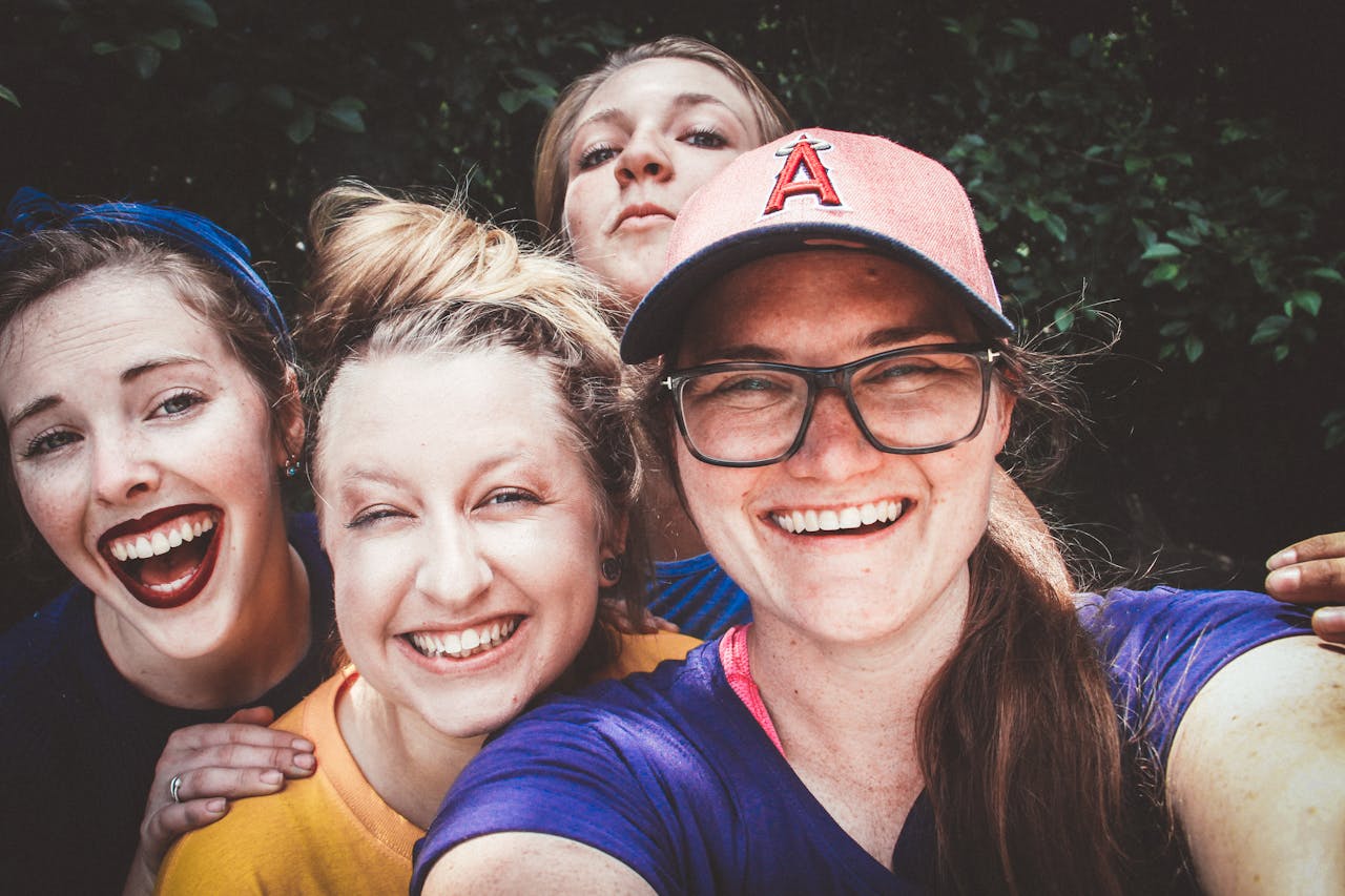 services-02 A joyful group of women taking a selfie outdoors, showcasing happiness and friendship.