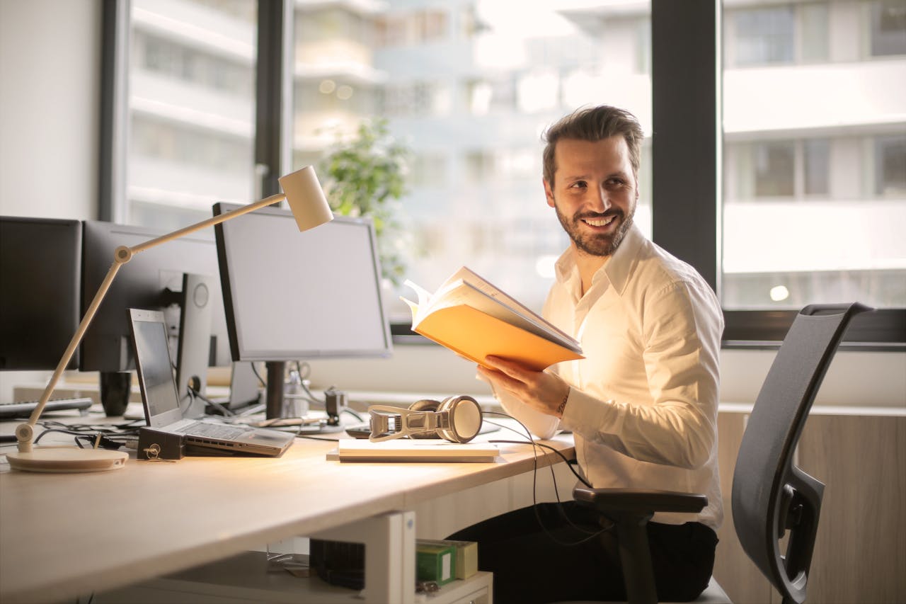about-03 A relaxed businessman enjoying a break in his bright, contemporary office environment.